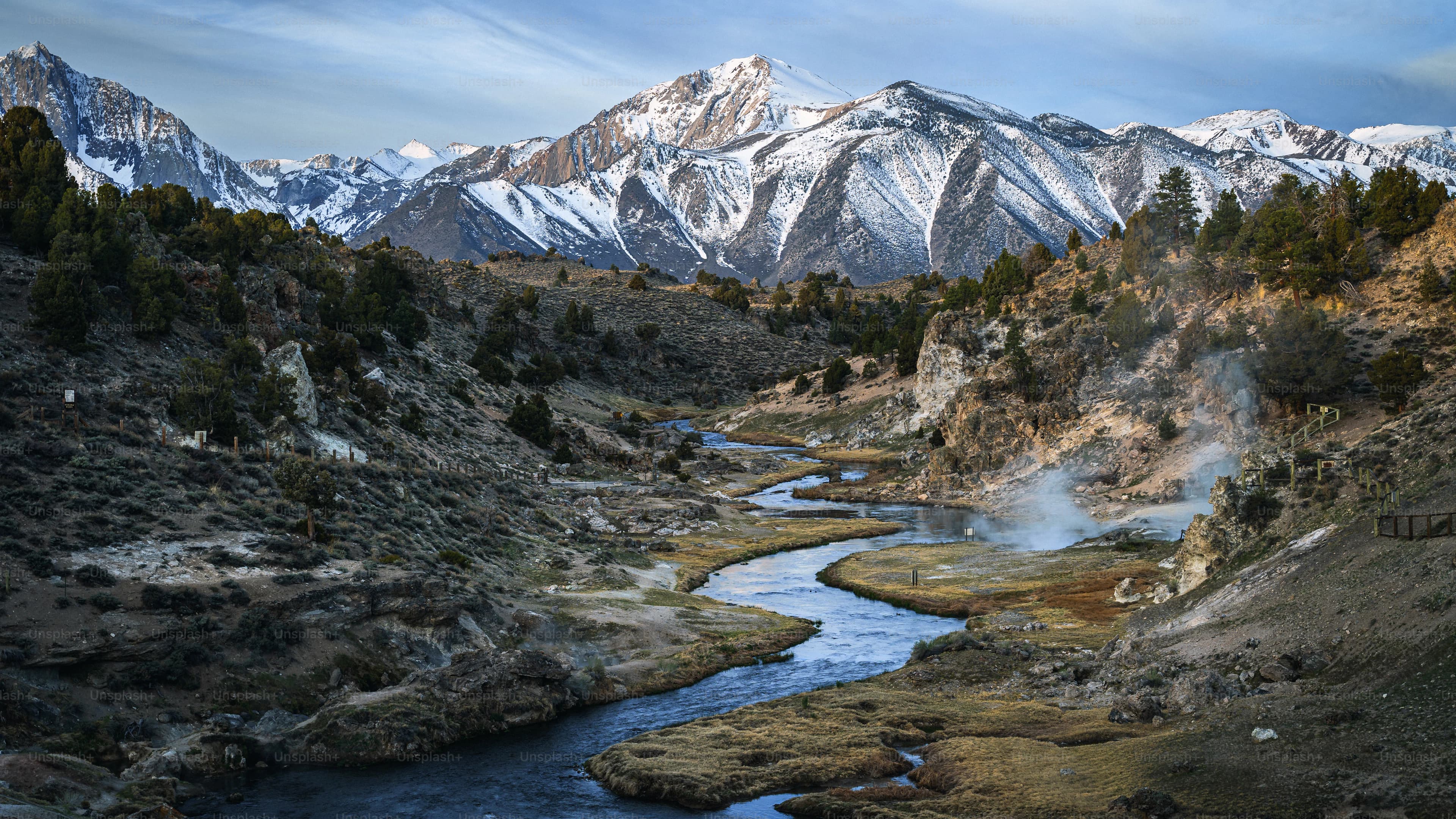 A river valley framed by steep mountains; representative route imagery.