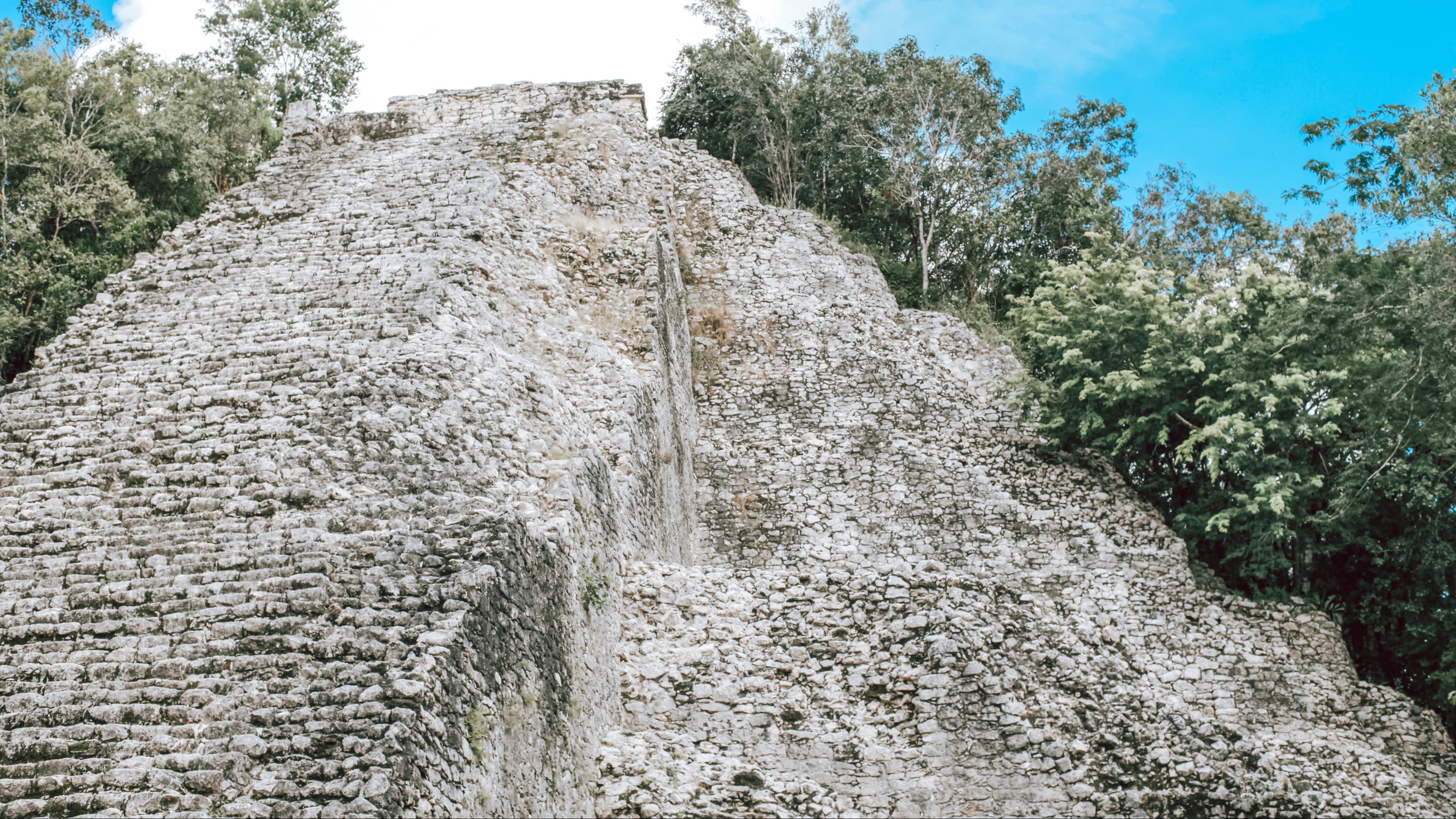 A Maya pyramid rising above tropical forest in southern Mexico.